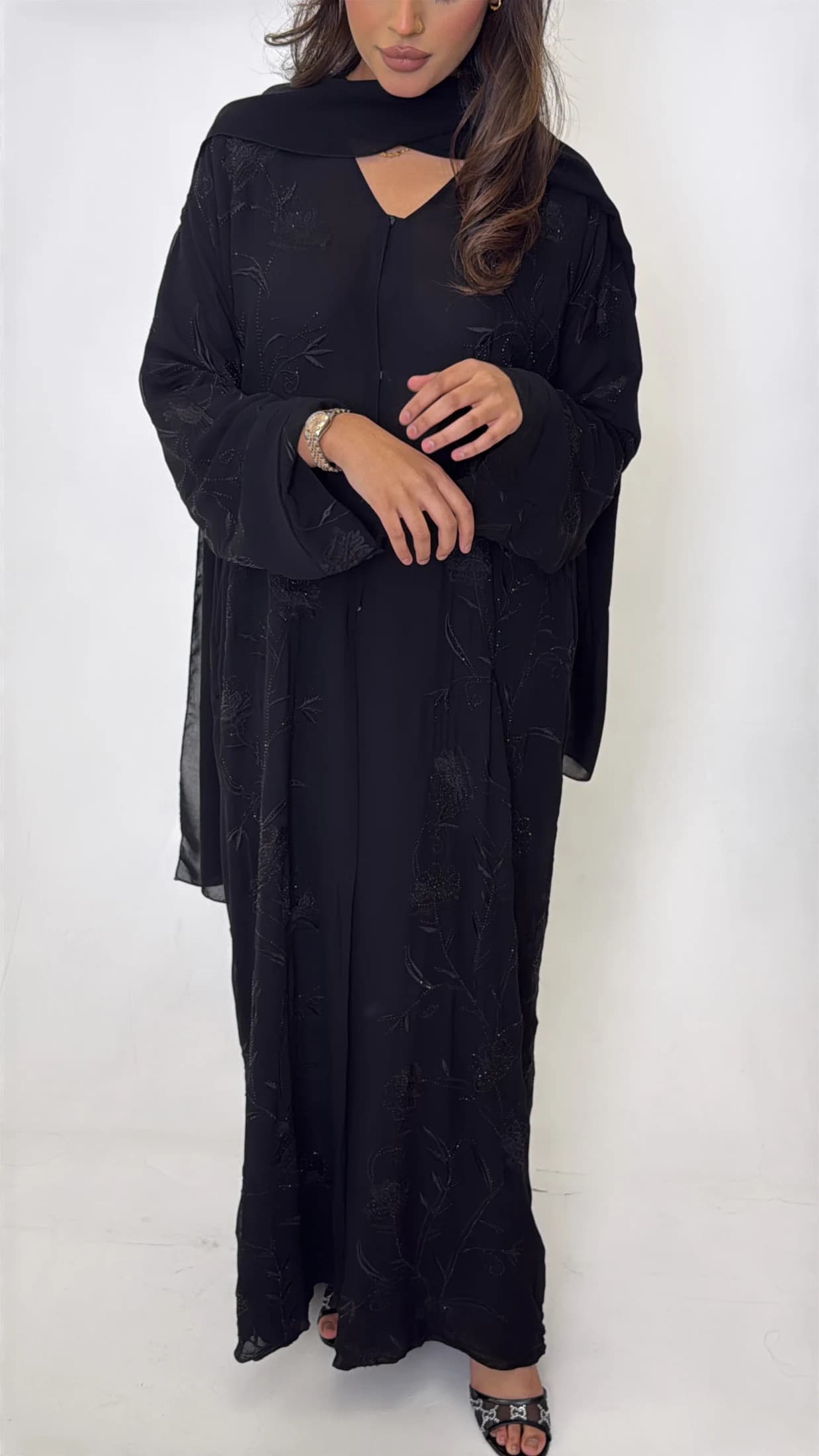Black abaya with tonal botanical details on the front and sleeves.