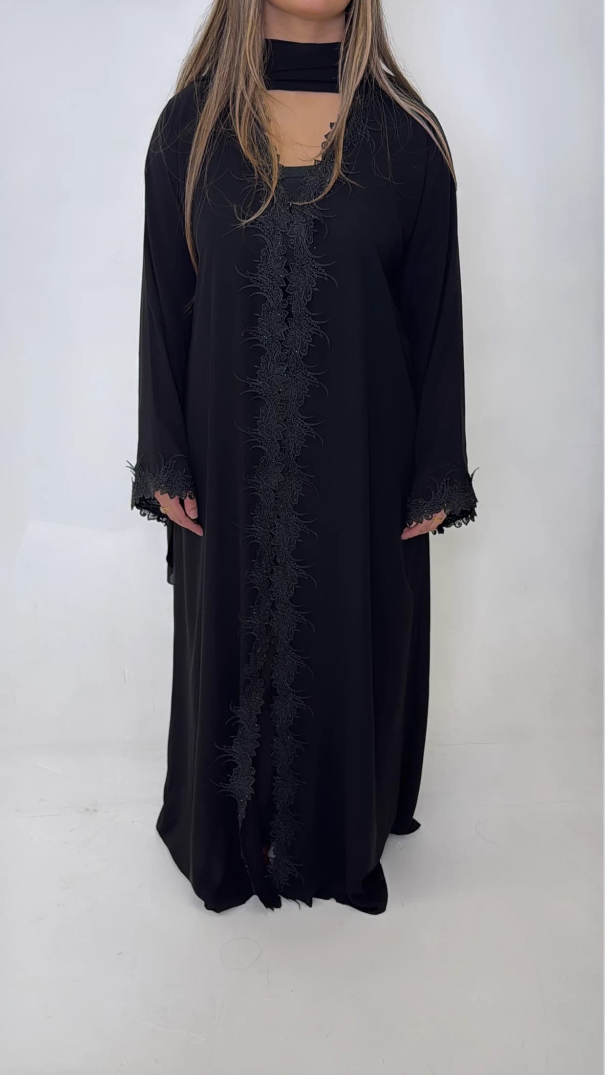 Black abaya with lace detailing along the opening and sleeves.